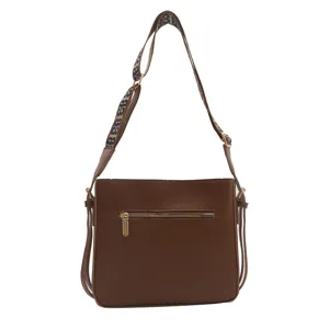 Brown leather shoulder bag for women with wide patterned strap and zipper pocket, stylish.