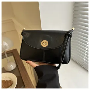 Vintage black crossbody shoulder bag with elegant gold turn-lock clasp and strap detail.