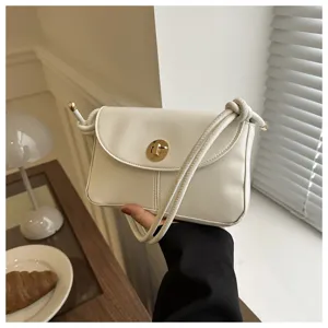 Minimalist solid white crossbody bag with chic knot strap and gold lock for women daily wear.