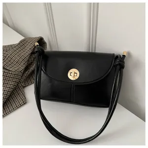 Detailed view of the black retro shoulder bag showcasing its gold turn-lock and strap knot.