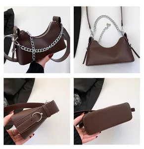 Detailed view of the brown underarm shoulder bag with a stylish silver chain design.