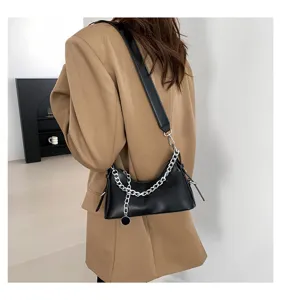 Fashionable black leather underarm shoulder bag with chunky silver chain detail for women.
