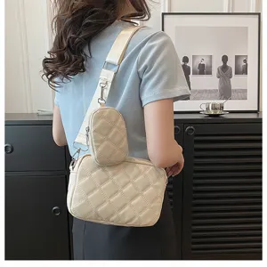 Quilted crossbody bag detail, featuring mother-child pouch design and wide strap style.