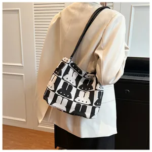 Knit shoulder tote bag featuring black and white checkerboard rabbit pattern for women.