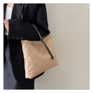 Beige quilted shoulder bag for women, stylish chain strap handbag, trendy autumn winter design.