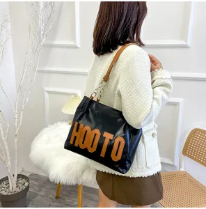 Black leather tote bag with letters, stylish large capacity shoulder bag for women.