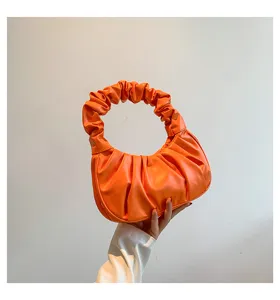 Orange ruched hobo bag detail, stylish pleat handle design, classic chic dumpling purse.