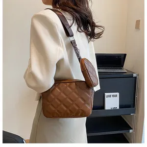 Detailed view of brown quilted crossbody shoulder bag with stylish strap coin pouch accessory.