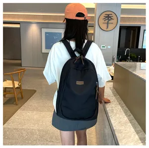 Classic black casual backpack for women and men, stylish school bag for daily commute travel.