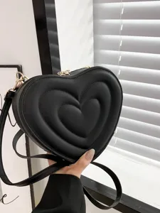 Black heart-shaped crossbody shoulder bag with quilted design and gold-tone hardware.