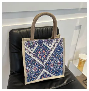 Ethnic style canvas tote bag detail, featuring geometric woven pattern and sturdy handles.