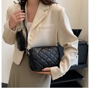 Details of black quilted PU leather camera shoulder bag with small detachable coin purse pouch.