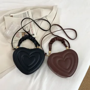 Chic heart-shaped crossbody bag for women, retro PU leather shoulder bag with ruched handle.