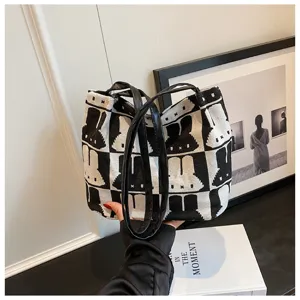 Chic black and white knit tote bag featuring a cute rabbit pattern and comfortable shoulder straps.
