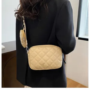 Detail view of stylish quilted crossbody shoulder bag with small pouch in beige PU leather.