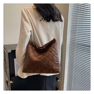 Brown quilted chain shoulder bag for women, large capacity stylish tote bucket bag detail view.