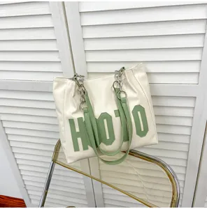 Women's large capacity white tote shoulder bag with green letter patch and chain strap for daily.