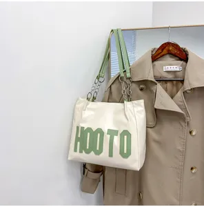 White PU leather tote bag with green letters and chain straps, large capacity women shoulder bag.
