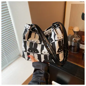 Fashionable black and white knitted shoulder bag for women, large capacity casual tote bag.