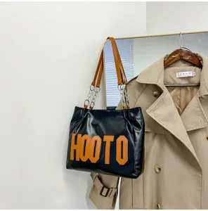 Women large black tote shoulder bag with brown straps and chain design for daily casual use.