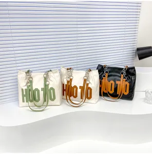 Stylish large capacity leather tote bag with letter print and chain straps for daily use.