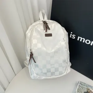 White shiny checkerboard backpack for daily travel, casual student bookbag with zip.