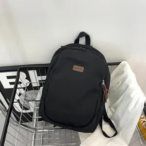 Classic solid color casual backpack detail shot, durable fabric, daily travel school bag.