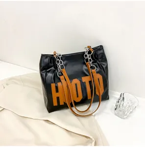 Fashionable large black letter tote bag for women, versatile shoulder bag with chain straps.