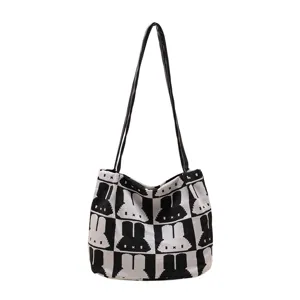Black and white knit tote bag detail showing cute rabbit pattern and large capacity design.