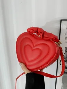Red heart-shaped crossbody bag for women, vintage PU leather fashion shoulder bag for summer.