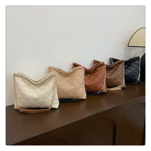 Close-up of stylish quilted chain shoulder bags in various colors displayed neatly.