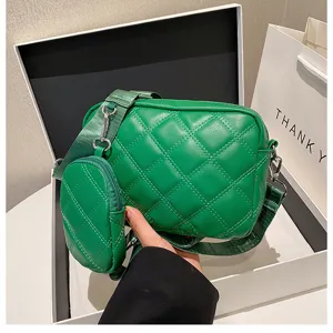 Green quilted PU crossbody bag detail showing classic diamond pattern and small coin purse.