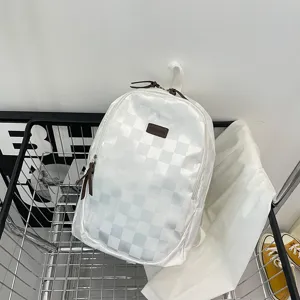 Detail view of the stylish white checkered backpack showing fabric texture and quality craft.