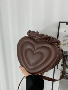 Retro heart-shaped shoulder bag for women, stylish PU leather crossbody bag, casual trendy purse.