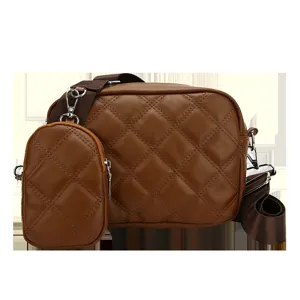 Detailed view of the brown quilted crossbody bag with small pouch, stylish PU leather design.