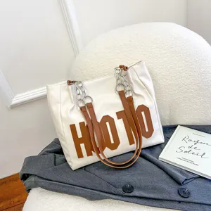 Fashion large capacity women tote bag casual white shoulder bag with brown letters.