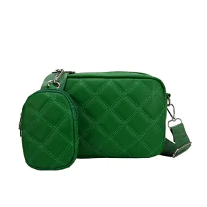Green quilted crossbody bag detail view, soft PU leather texture, detachable coin pouch.