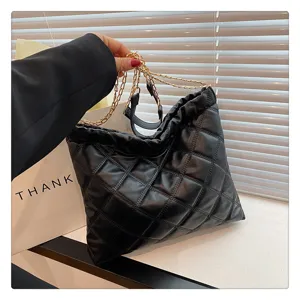 Detailed view of black quilted leather handbag with stylish gold chain strap and large capacity
