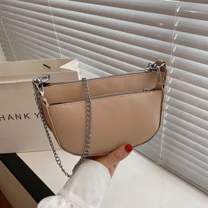 Women beige PU leather saddle bag with silver chain strap trendy underarm shoulder handbag.