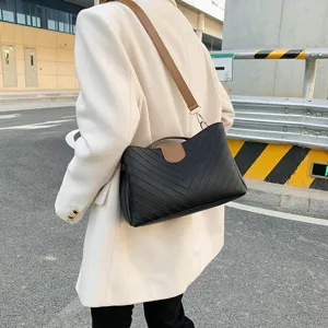 Elegant black shoulder bag for women, chic chevron quilted design with brown straps.