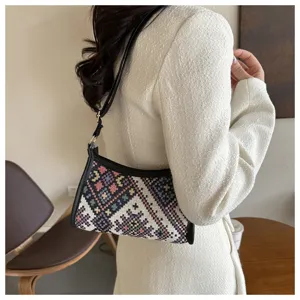 Ethnic woven underarm shoulder bag for women, stylish patterned hobo handbag with black leather trim.