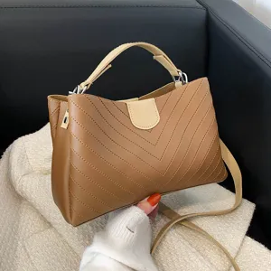 Trendy brown underarm shoulder bag for women, chic chevron quilted design with top handle.