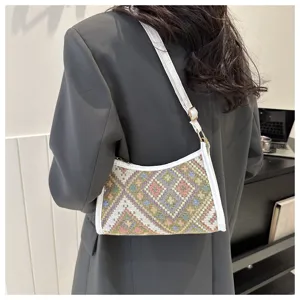 Ethnic pattern underarm shoulder bag for women, stylish crescent handbag with white trim detail.