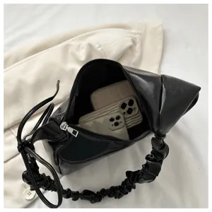 Black pleated shoulder hobo bag detail view showing interior capacity and soft texture.