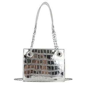 Silver metallic crocodile pattern handbag detail showcasing shiny texture, chain strap, and metal rings.