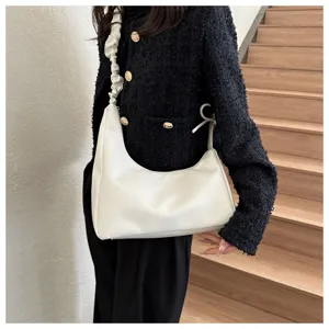 White underarm shoulder bag detail, stylish crescent handbag with pleated strap design.