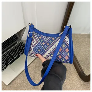 Ethnic woven underarm shoulder bag with blue PU trim and geometric pattern design.