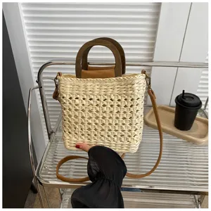 Woven straw bucket bag with wooden handles and shoulder strap for women casual stylish summer use.