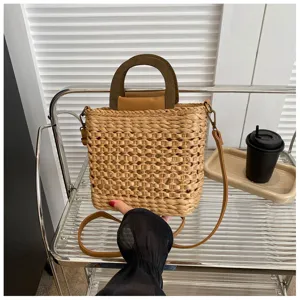 Woven straw bucket bag with wooden top handle and shoulder strap, casual stylish summer handbag.