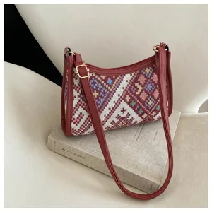 Ethnic woven crescent shoulder bag for women, stylish autumn crossbody handbag with leather trim.